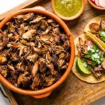 Slow Cooker Pork Carnitas Served with Tacos